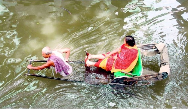 Kolkata's waterlogged streets, hand-pulled rickshaws in water