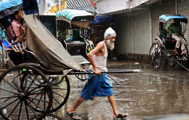 Kolkata in rains, hand-pulled rickshaws in rains